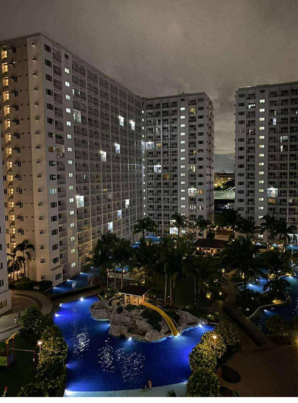 Night view of the residential towers and lagoon pools where Maison Lumière units are located
