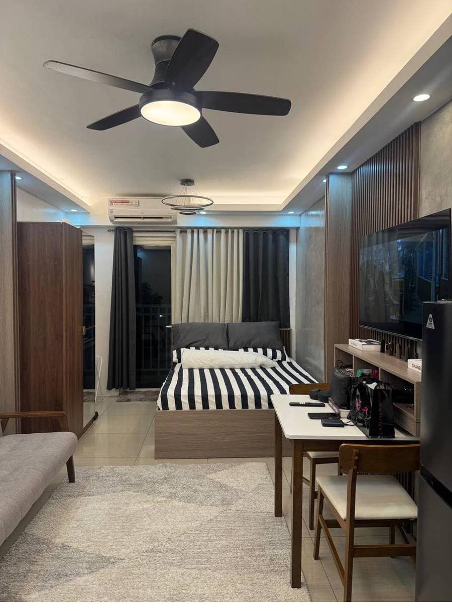Wide view of a styled studio with sofa and workspace