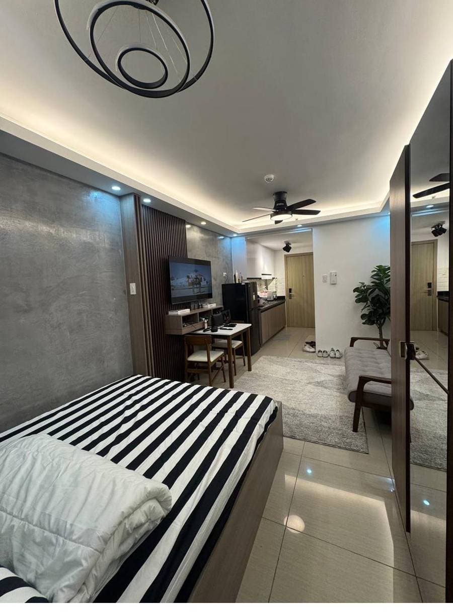 Styled studio suite with designer bed and accent wall